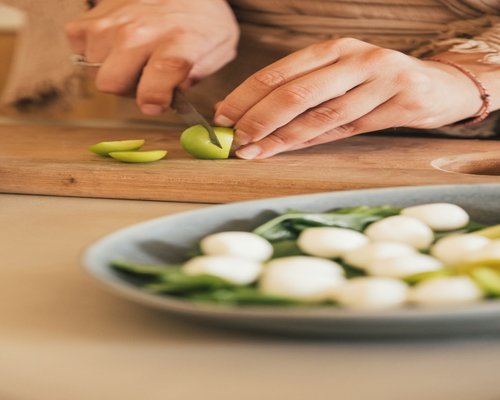 Person preparing a healthy meal with fresh ingredients at home